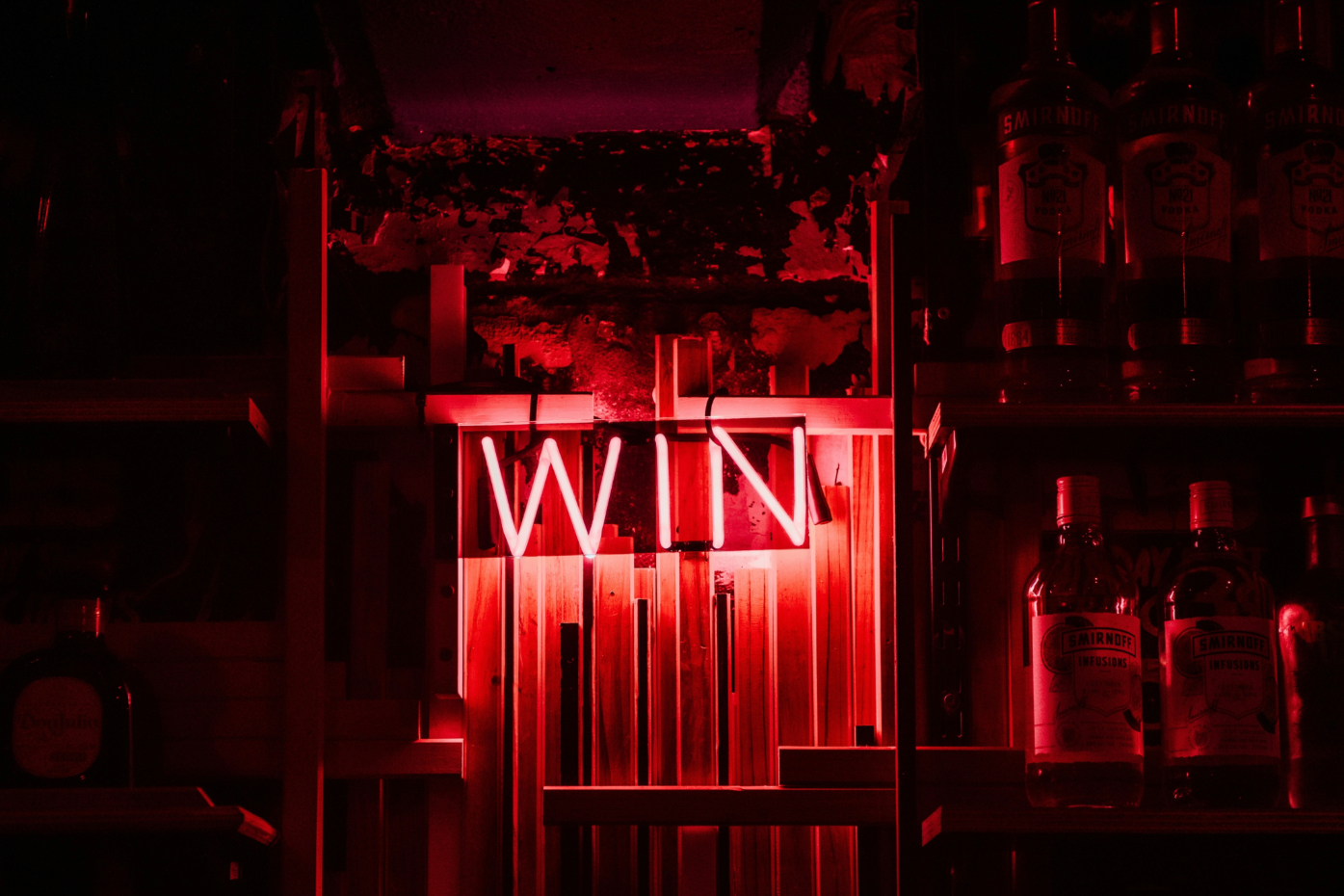 photograph of a neon sign that says "win"